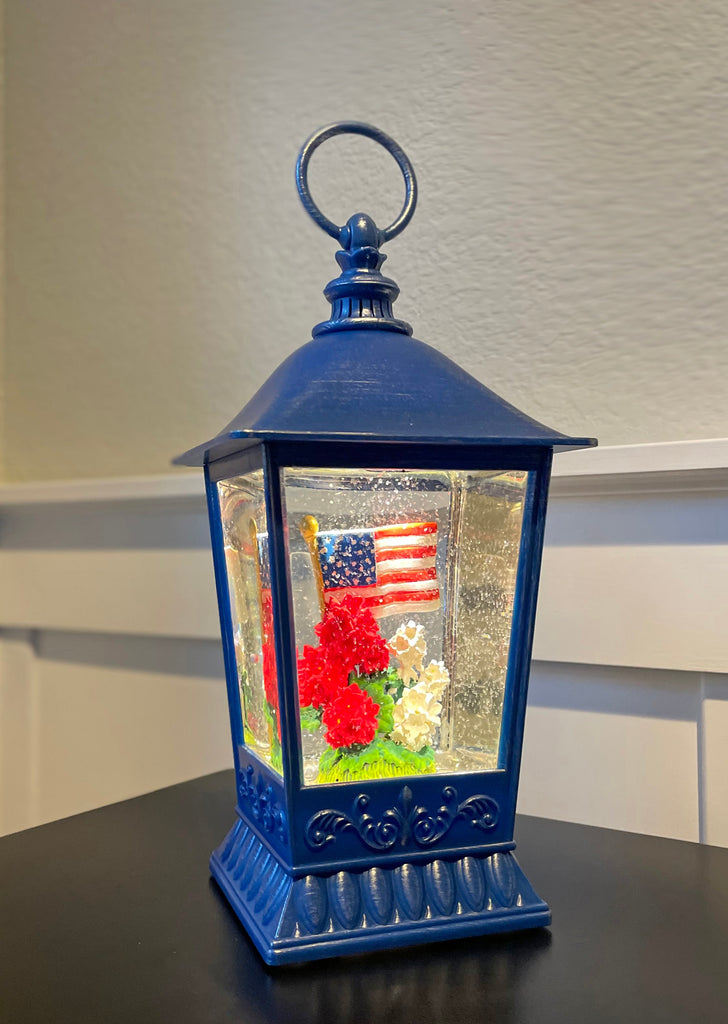 Patriotic Water Lantern with American Flag, 11.5 Inch, LED Light, Swirling Glitter Snow Globe Design, Battery/USB Powered, Blue, Red and White Geranium Flowers