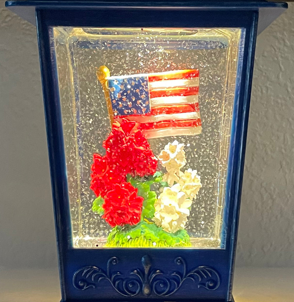 Patriotic Water Lantern with American Flag, 11.5 Inch, LED Light, Swirling Glitter Snow Globe Design, Battery/USB Powered, Blue, Red and White Geranium Flowers