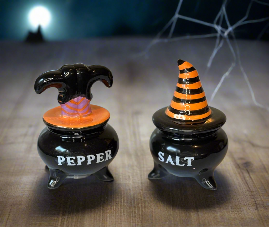 Halloween-themed pepper and salt shakers with witch hats on a white background